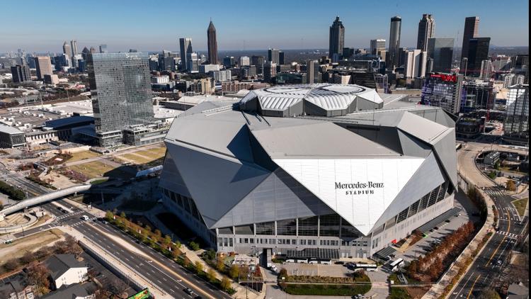Atlanta skyline at sunset with State Farm Arena lit up, symbolizing a city ready for major events.
